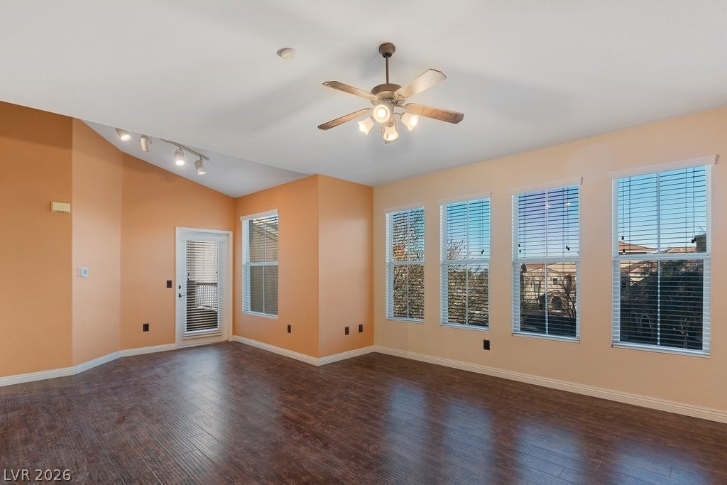 10001 Peace Way, Unit 2311 Las Vegas, NV 89147 - Photo 9 of 35 Spare room with dark wood finished floors, lofted ceiling, and a ceiling fan