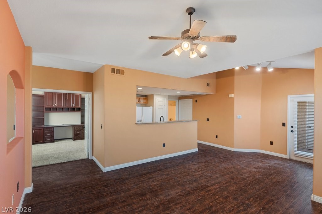 10001 Peace Way, Unit 2311 Las Vegas, NV 89147 - Photo 10 of 35 Unfurnished living room featuring a ceiling fan and dark wood-style flooring