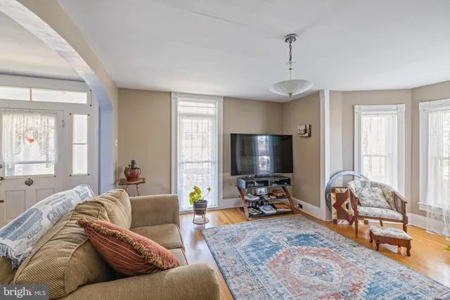a living room with furniture a couch and a flat screen tv