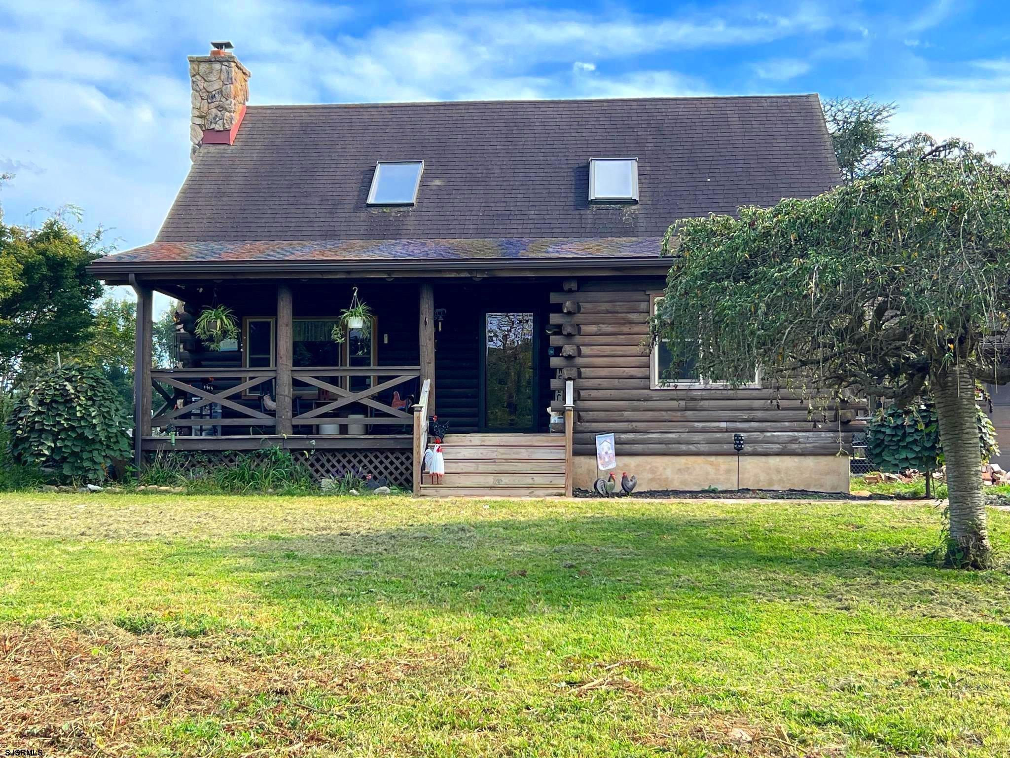 a view of a house with swimming pool and a yard