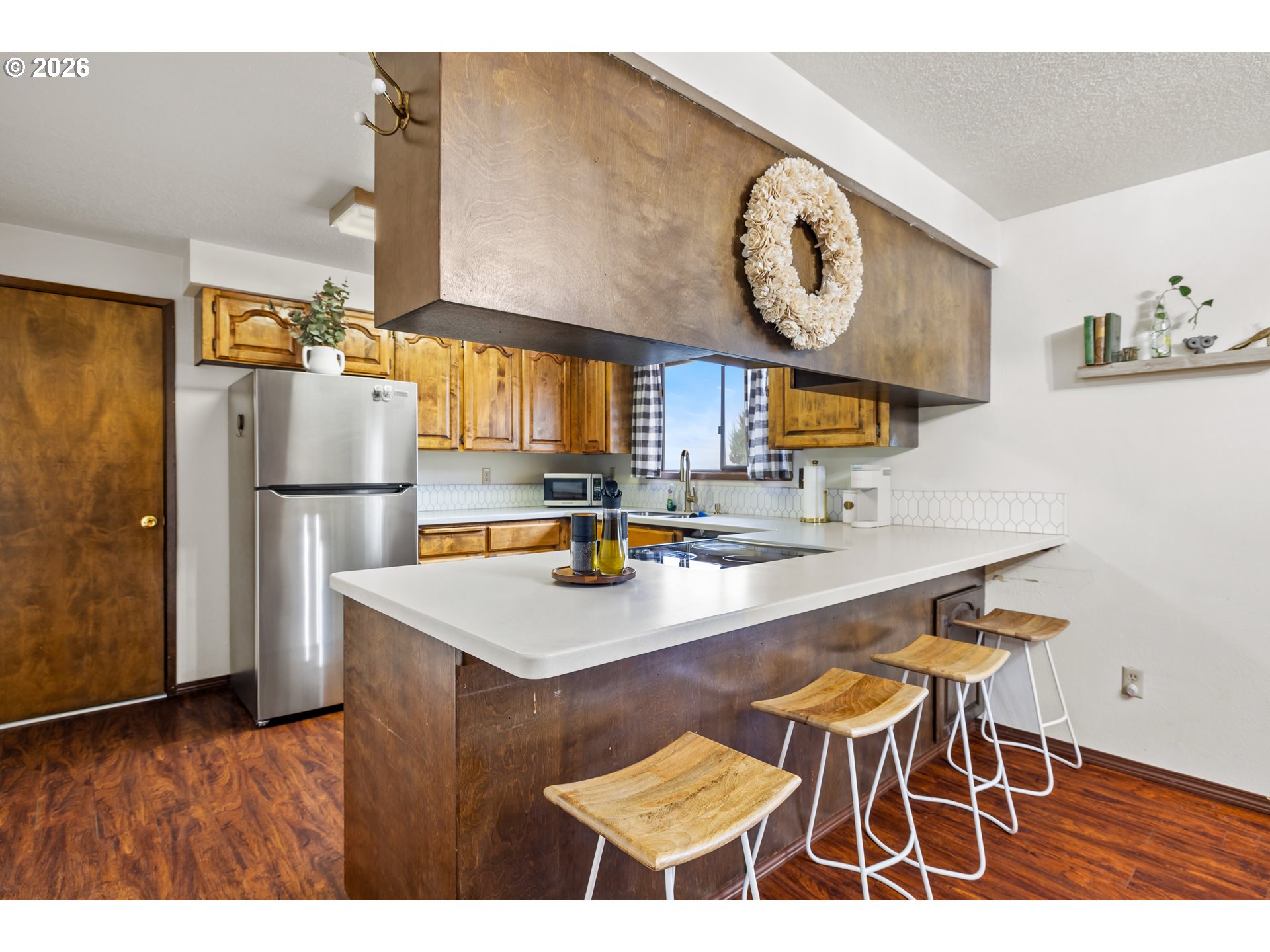 414 Monroe Street Umatilla, OR 97882 - Photo 6 of 19 a kitchen with stainless steel appliances granite countertop a sink a stove and a refrigerator