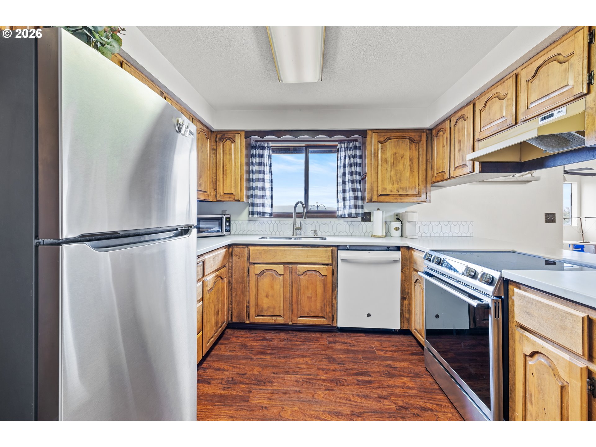 414 Monroe Street Umatilla, OR 97882 - Photo 7 of 19 a kitchen with stainless steel appliances granite countertop a sink a stove a refrigerator with grey cabinets