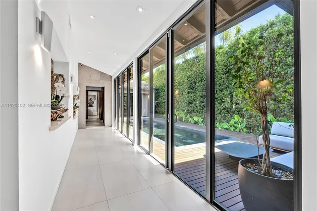 a large white kitchen with a large window and counter space