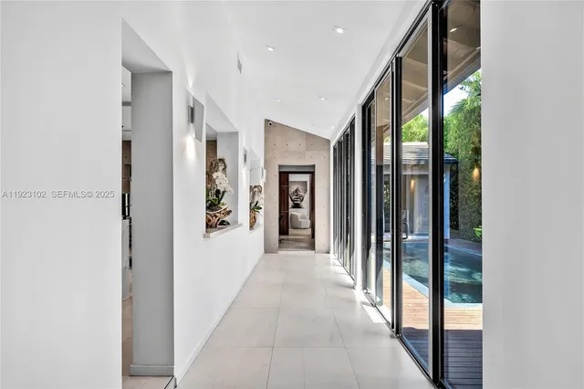 a view of a hallway with wooden floor and a large window