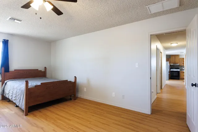 a bedroom with a bed and a ceiling fan