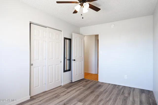 a bedroom with a bed and large window