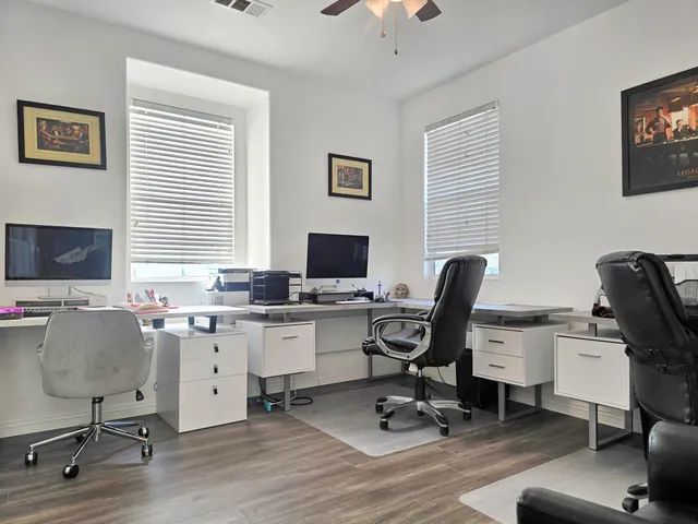 a bedroom with a bed a dresser and a book shelf