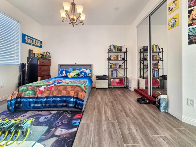 a bathroom with a granite countertop sink toilet and mirror