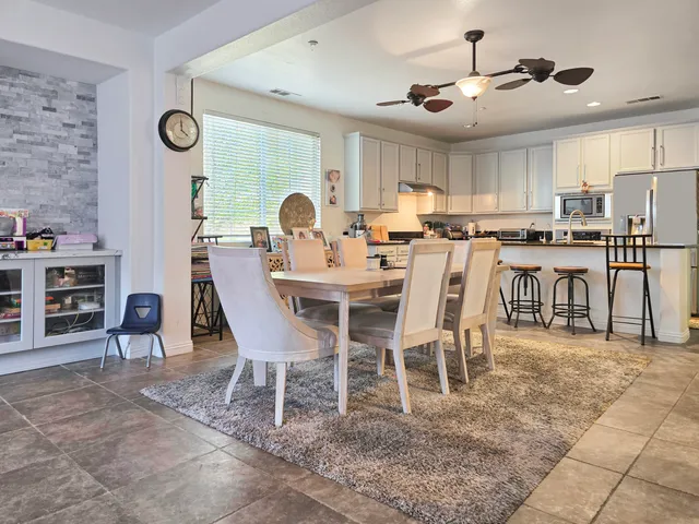 a kitchen with kitchen island granite countertop a sink appliances and cabinets