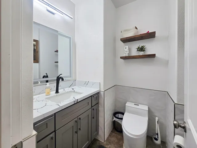a view of a bedroom with wooden floor
