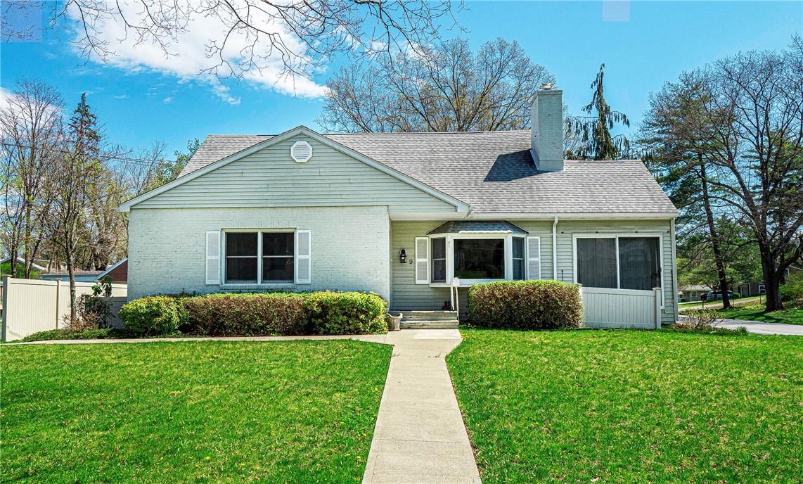 a front view of a house with a garden and yard