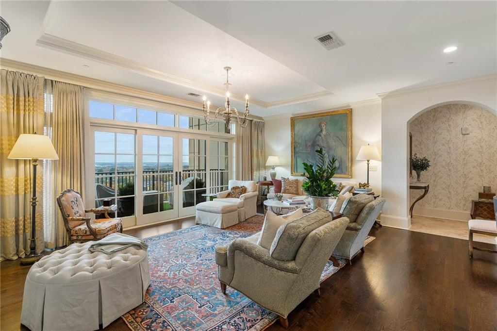a living room with furniture and a chandelier