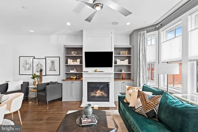 a living room with furniture fireplace and flat screen tv