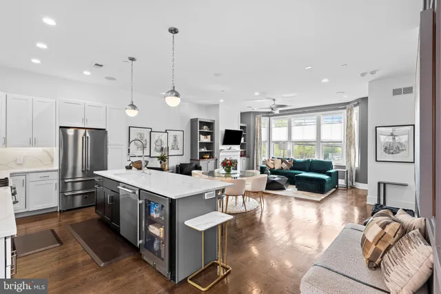 a open kitchen with stainless steel appliances granite countertop a stove and a refrigerator