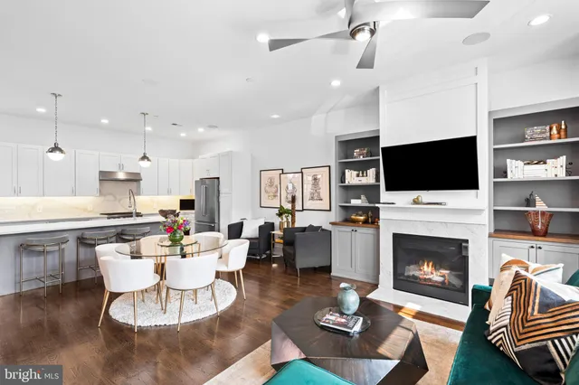 a living room with fireplace furniture and a flat screen tv