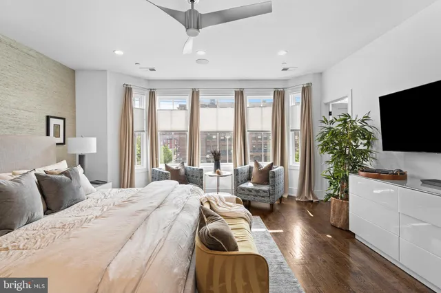 a bedroom with furniture and a flat screen tv