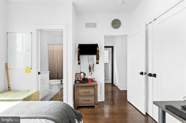 a bedroom with a bed and a view of bathroom