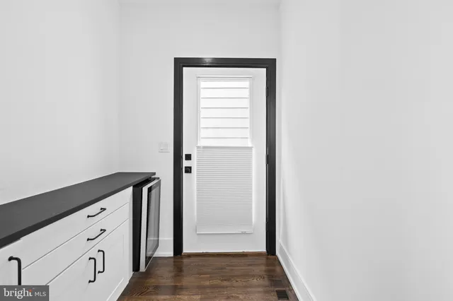 a view of hallway with closet and wooden floor