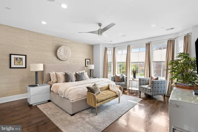 a bedroom with a large bed and a large window