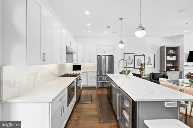 a large kitchen with a table and chairs