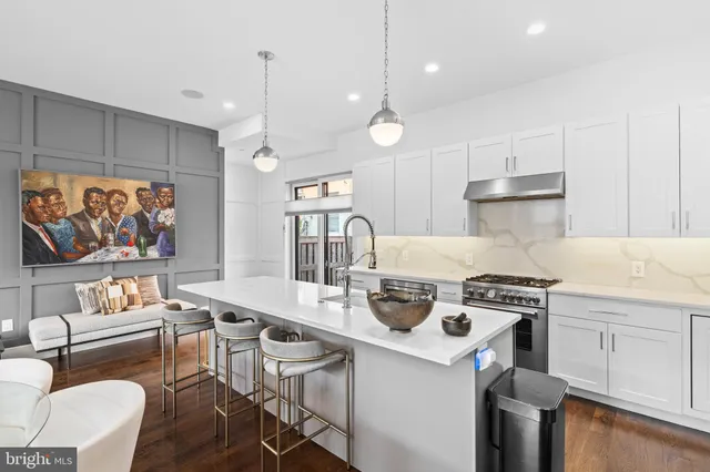 a kitchen with a stove a refrigerator and a dining table with wooden floor