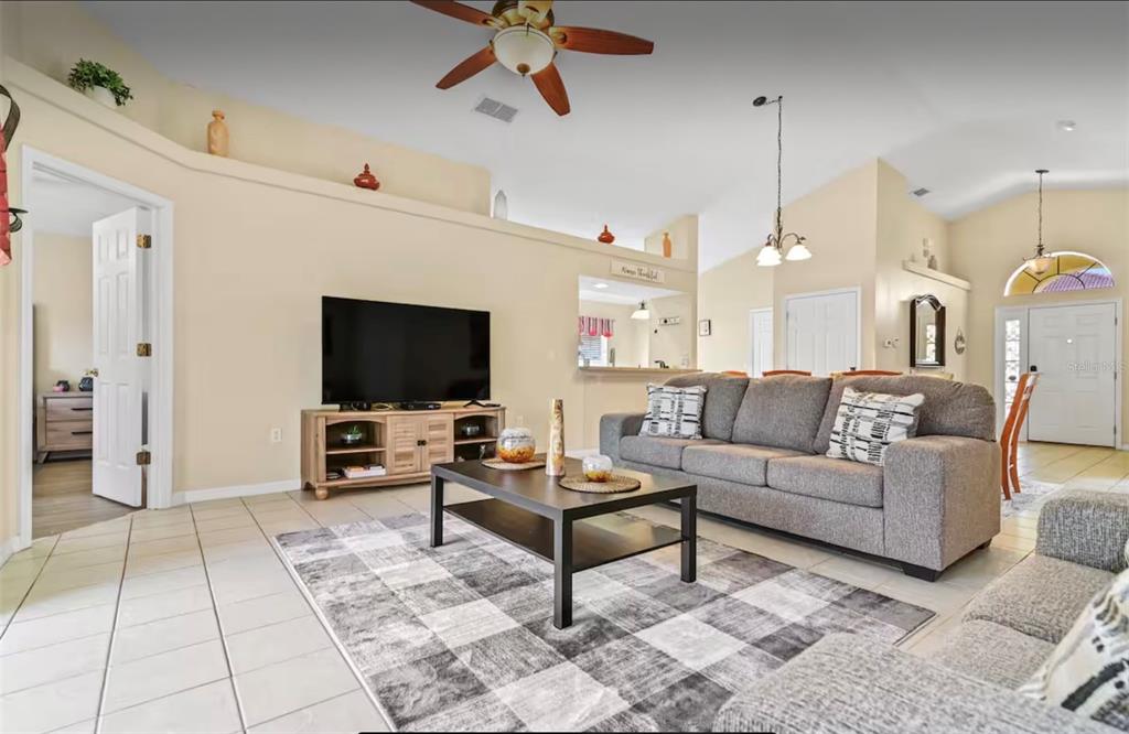 100 Cardinal Court Davenport, FL 33896 - Photo 11 of 30 a living room with furniture and a flat screen tv