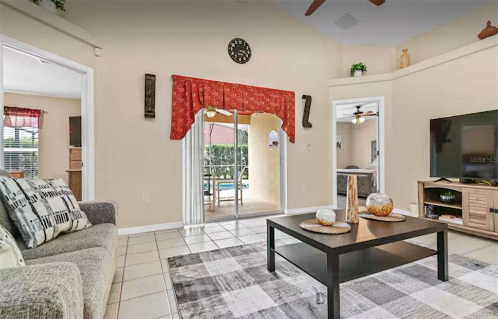 100 Cardinal Court Davenport, FL 33896 - Photo 13 of 30 a living room with furniture and a flat screen tv