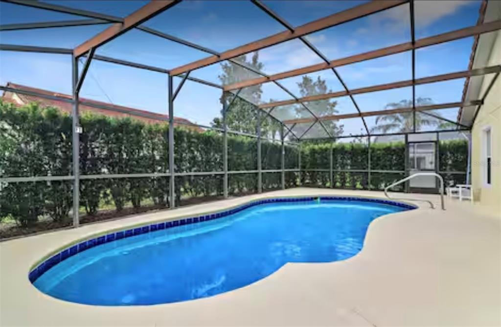 100 Cardinal Court Davenport, FL 33896 - Photo 2 of 30 a view of a swimming pool with a porch