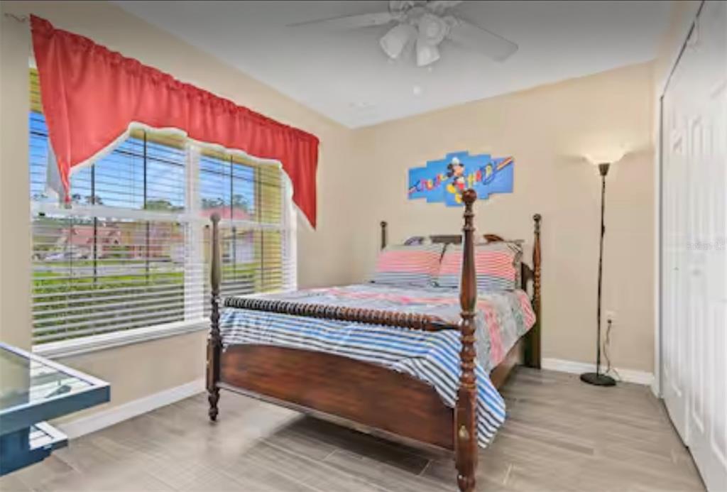100 Cardinal Court Davenport, FL 33896 - Photo 21 of 30 a bedroom with a bed and a window