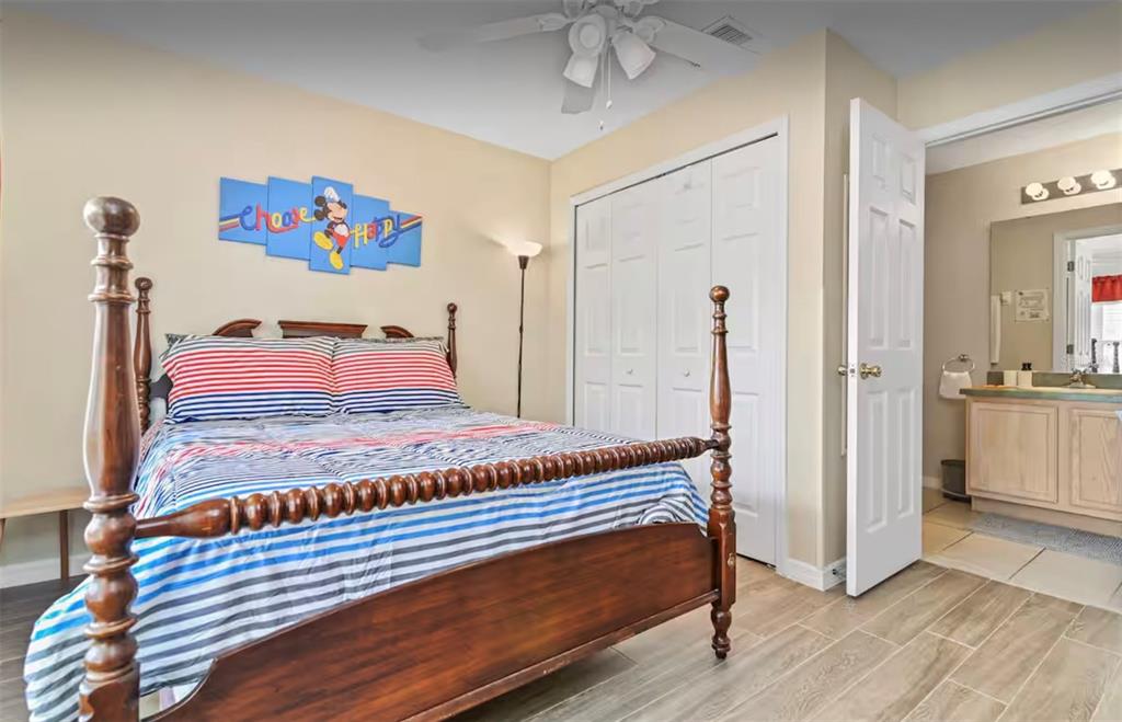 100 Cardinal Court Davenport, FL 33896 - Photo 23 of 30 a bedroom with a bed and a view of bathroom