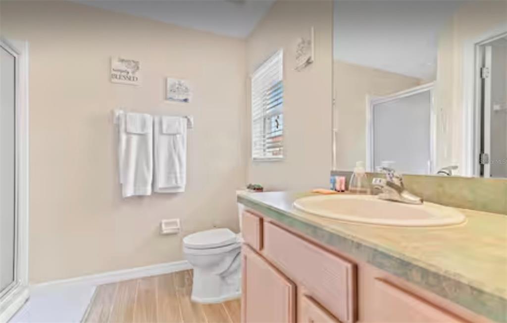 100 Cardinal Court Davenport, FL 33896 - Photo 25 of 30 a bathroom with a granite countertop sink and a mirror