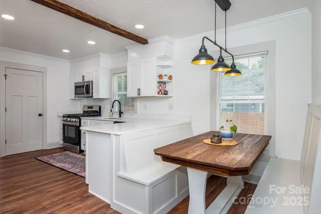 a kitchen with a sink a counter space appliances and cabinets
