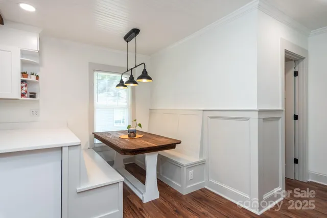 a view of a room with furniture and wooden floor