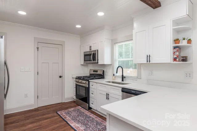 a kitchen with a sink a stove and cabinets