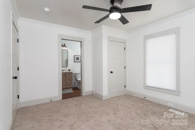 an empty room with chandelier fan