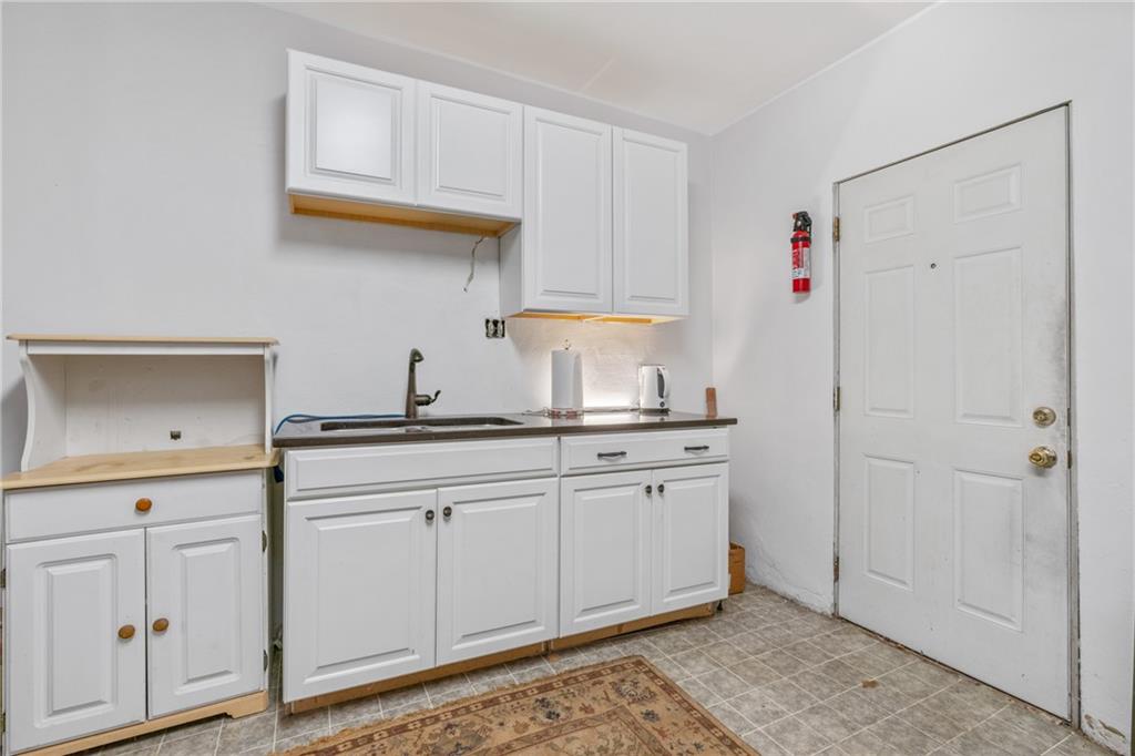 6824 Butler Street Pittsburgh, PA 15206 - Photo 12 of 26 a kitchen with white cabinets and sink