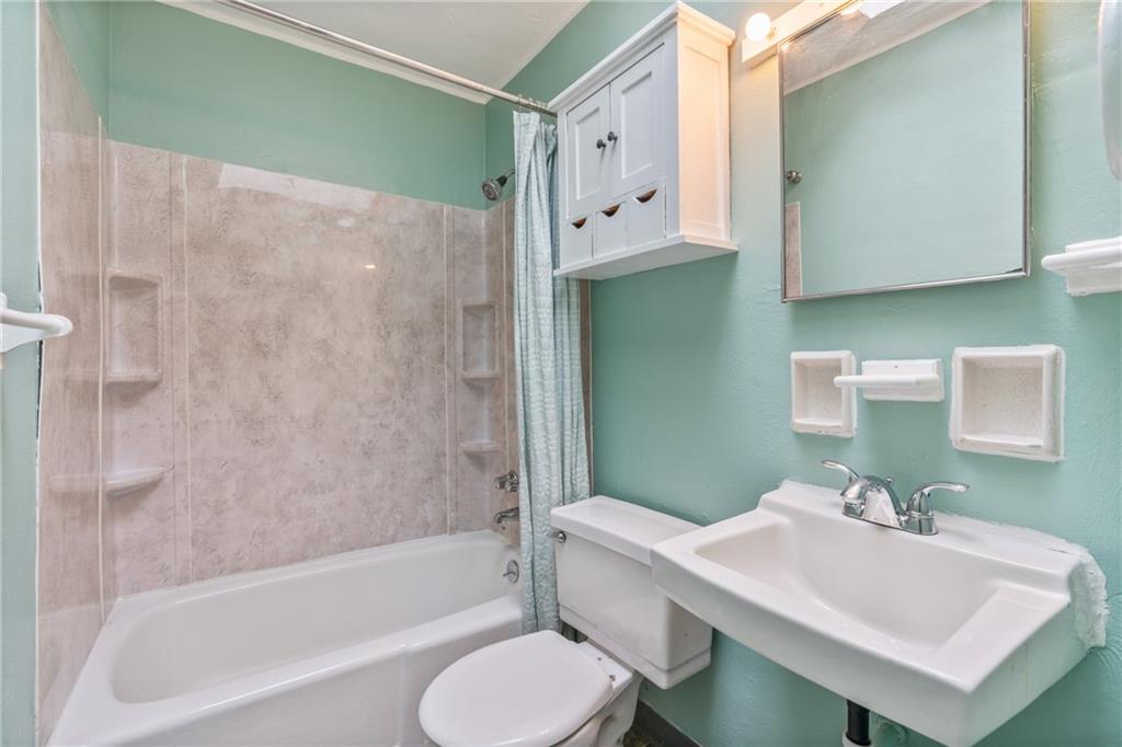 6824 Butler Street Pittsburgh, PA 15206 - Photo 17 of 26 a bathroom with a sink toilet and shower