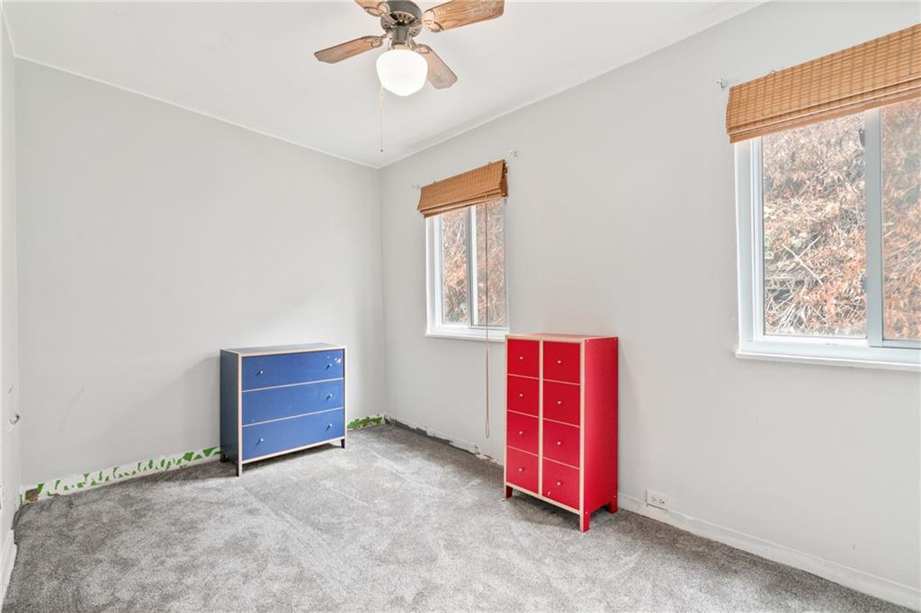 6824 Butler Street Pittsburgh, PA 15206 - Photo 18 of 26 an empty room with windows and fan