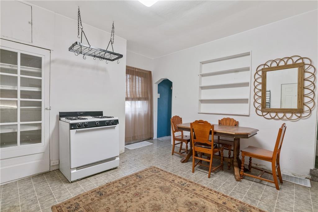 6824 Butler Street Pittsburgh, PA 15206 - Photo 10 of 26 a kitchen with stainless steel appliances granite countertop a dining table chairs and granite counter tops