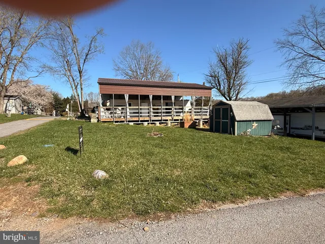 a view of a house with backyard porch and sitting area