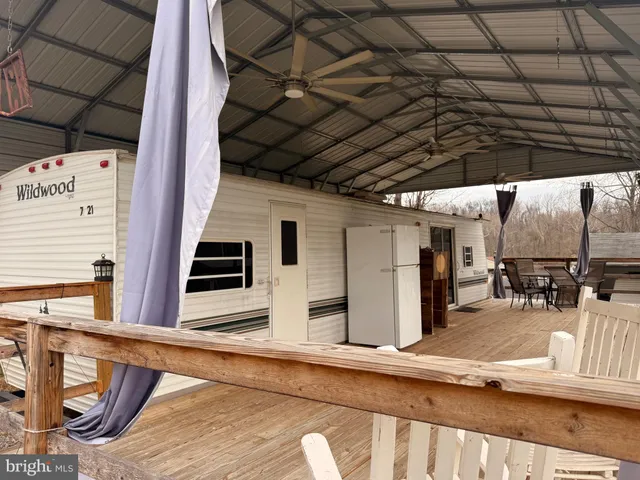 a view of a porch with furniture and a yard