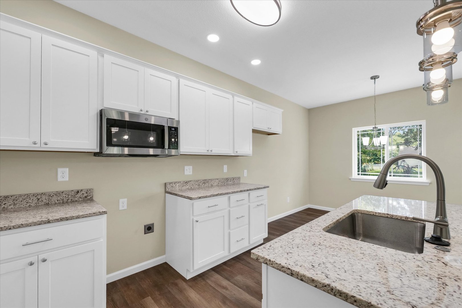 5 Montclair Road, Unit A Urbana, IL 61801 - Photo 13 of 33 a kitchen with granite countertop white cabinets and a stove top oven