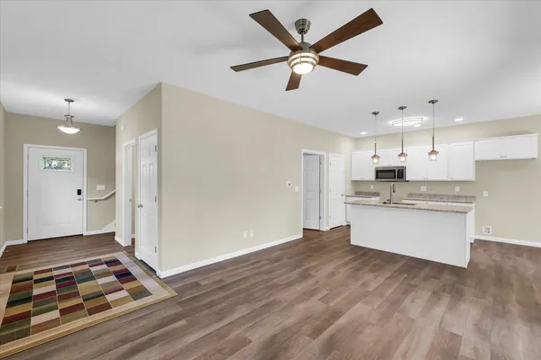 a kitchen with stainless steel appliances granite countertop a refrigerator and a stove top oven