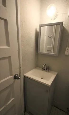 a white refrigerator freezer and a stove sitting inside of a kitchen