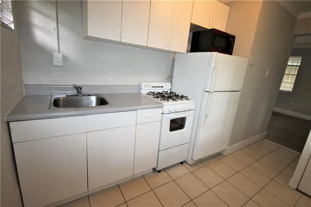 a white refrigerator freezer sitting inside of a kitchen