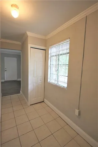 a view of a kitchen with a refrigerator a microwave and cabinets