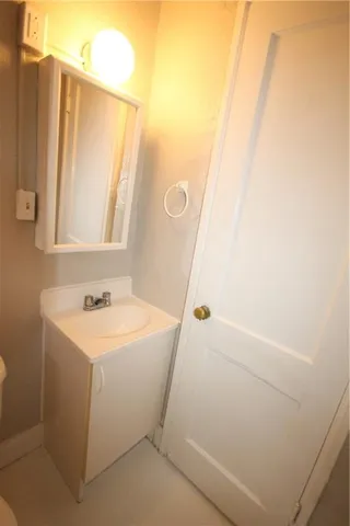 an empty room with wooden floor and entrance