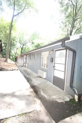 an empty room with wooden floor & windows