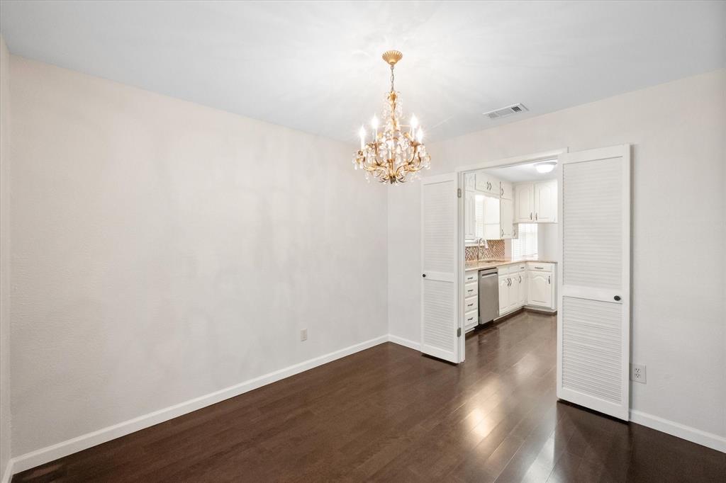 2003 Botts Drive Arlington, TX 76012 - Photo 16 of 40 a view of a room with wooden floor and chandelier