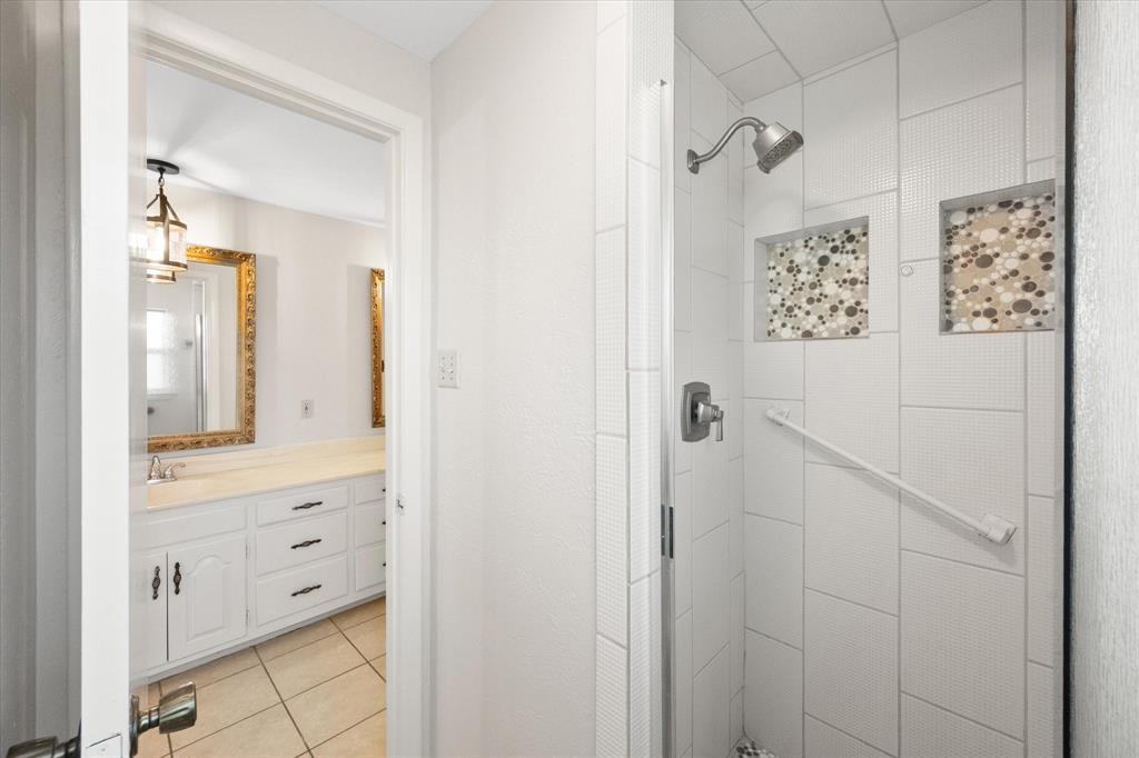 2003 Botts Drive Arlington, TX 76012 - Photo 26 of 40 a bathroom with a shower and a mirror